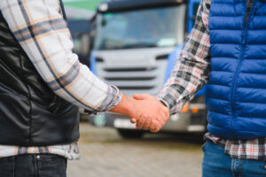 Two men shaking hands outside